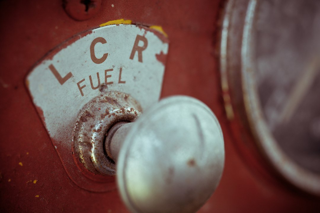 Car fuel gauge illustrating standard mileage vs actual expenses for delivery drivers